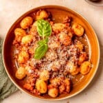 A bowl of gnocchi with bolognese.