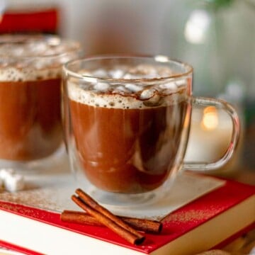 A clear mug filled with hot chocolate.