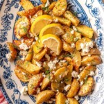 Greek lemon potatoes with feta and topped with lemon slices.