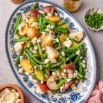Potato and green bean salad, showing the texture of the potatoes, crisp green beans, and creamy feta crumbles.