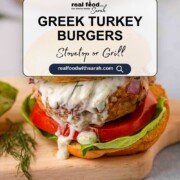 Juicy Greek turkey burger topped with tzatziki, lettuce, and tomato—great for grilling or stovetop dinners.