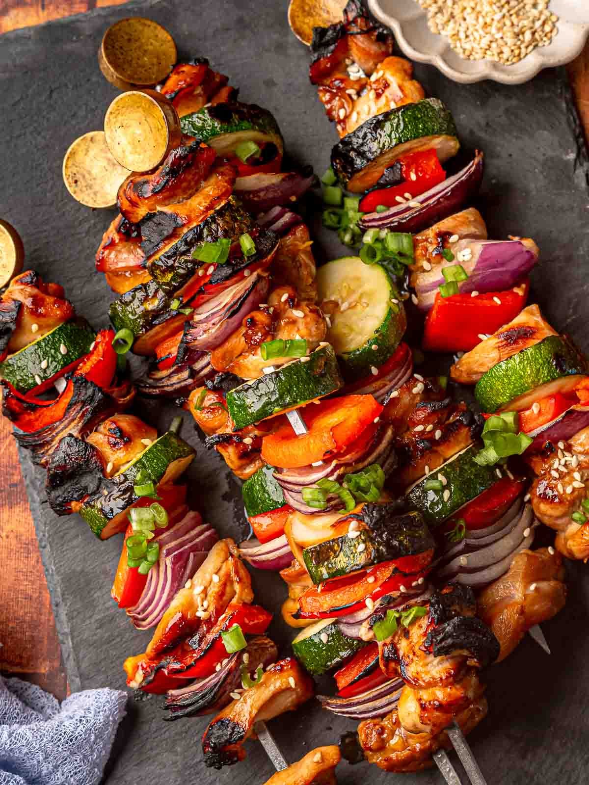Juicy grilled chicken kabobs with zucchini, red onion, and bell peppers.