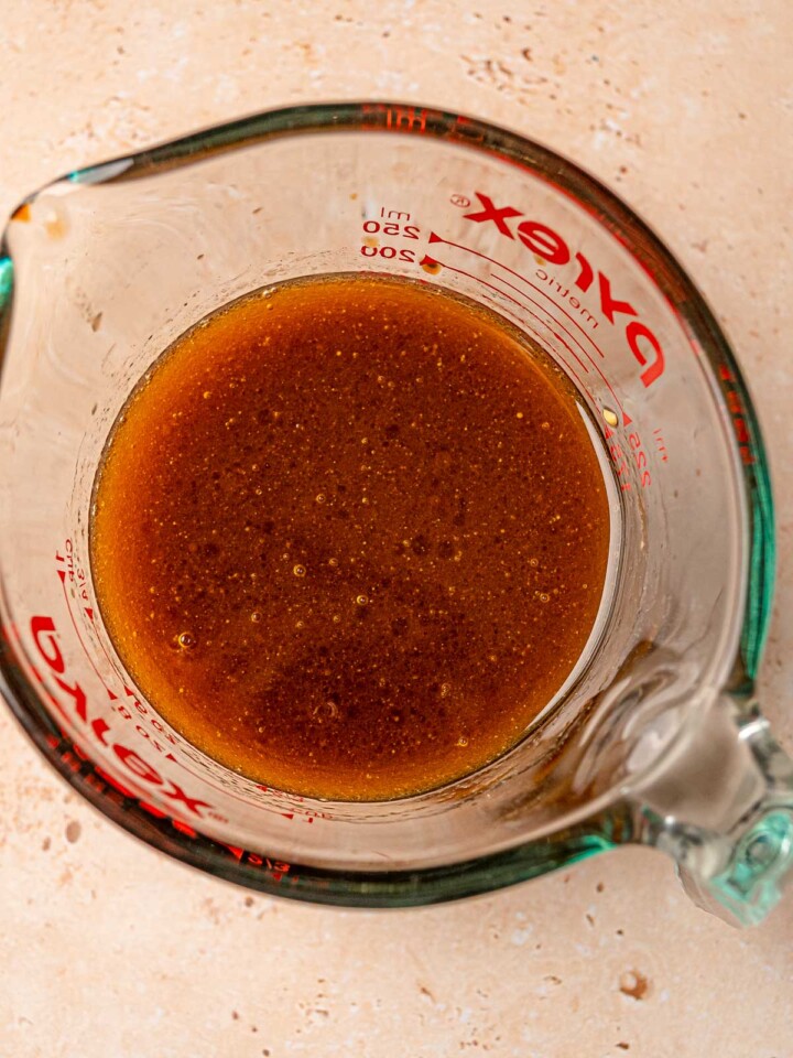 Honey balsamic vinaigrette in a glass measuring cup for Cobb salad dressing.