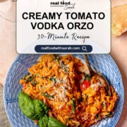 Pinterest graphic for creamy tomato vodka orzo with basil and parmesan on a blue plate.