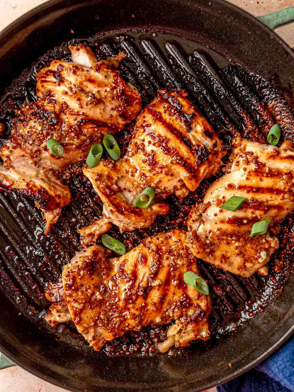 Juicy grilled chicken thighs topped with whole grain mustard and fresh scallions.