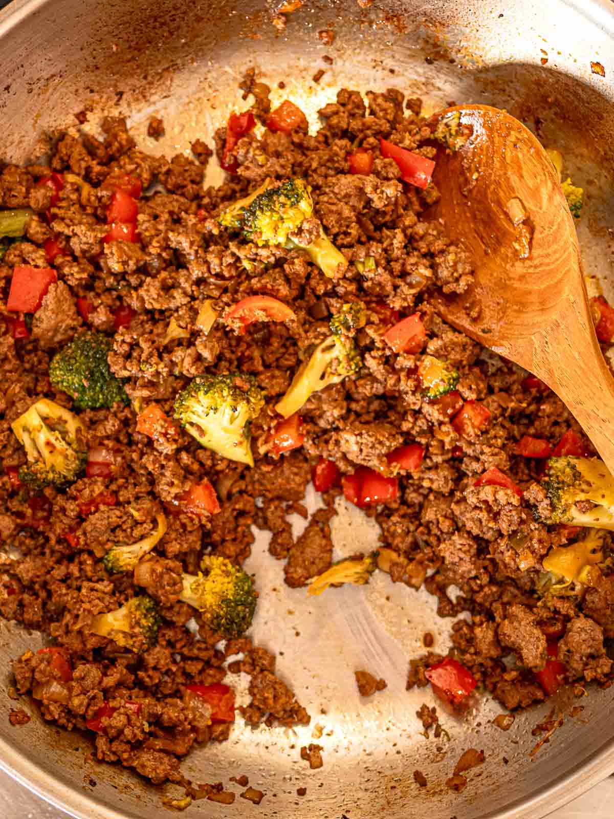 Ground beef, broccoli, and peppers combined in a skillet with teriyaki sauce.