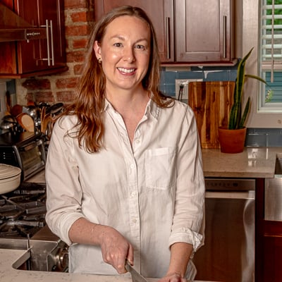 Sarah Hill, food blogger behind Real Food with Sarah, in her kitchen preparing fresh ingredients for a weeknight dinner.