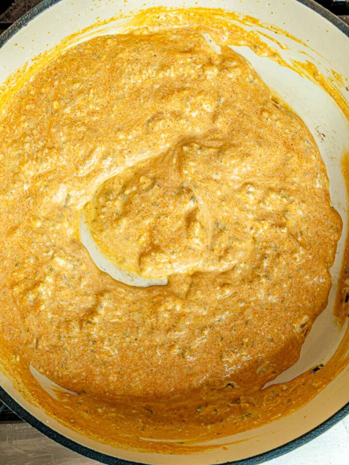 Smooth, blended buffalo sauce simmering in a pot, forming the base for pasta.