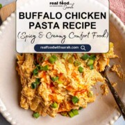 A creamy buffalo chicken pasta served on a white plate, topped with a drizzle of hot sauce and fresh green onions for a spicy and comforting dinner.