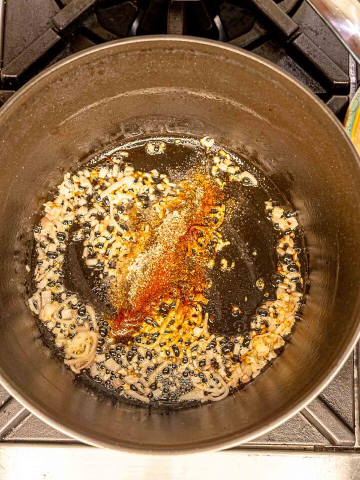 Shallot, garlic and spices in a pot.