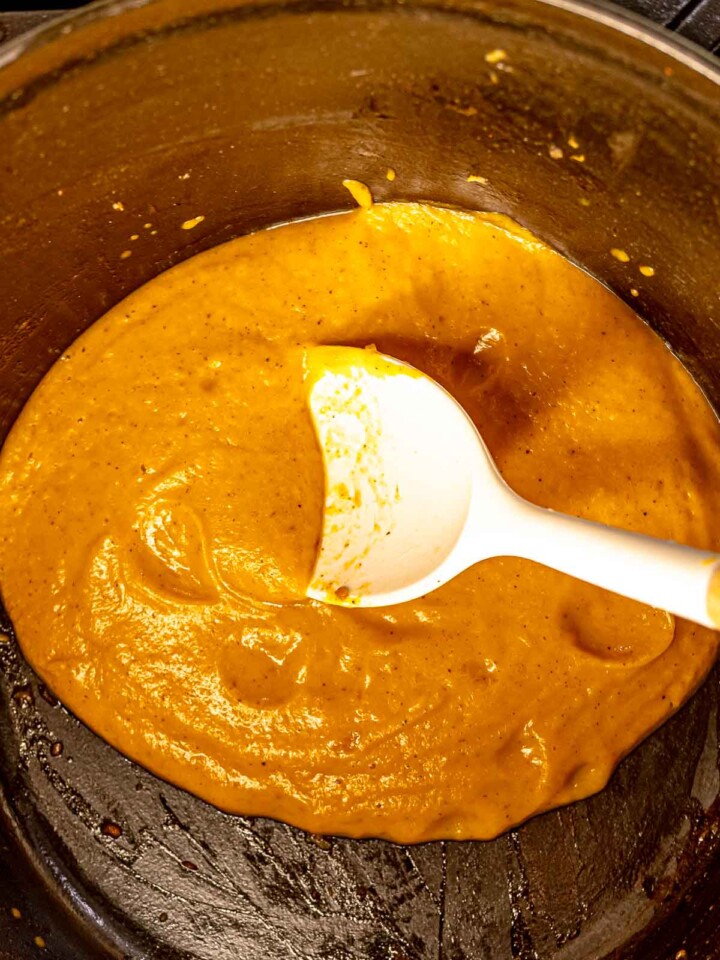 Blended butternut squash purée forming a smooth, creamy base in the pot.