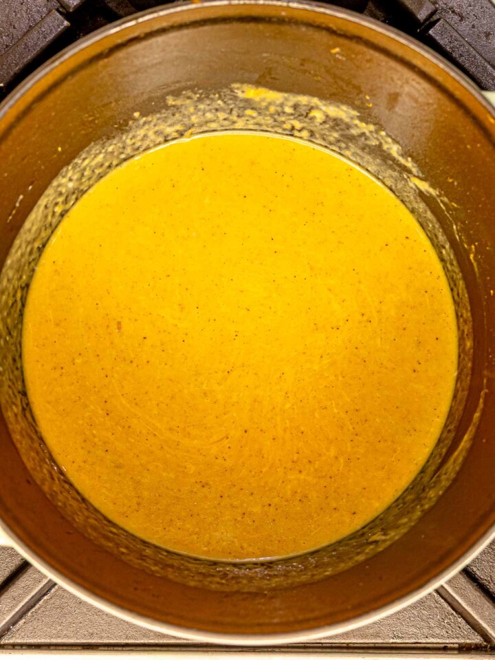 Velvety butternut squash cheese sauce simmering in the pot.