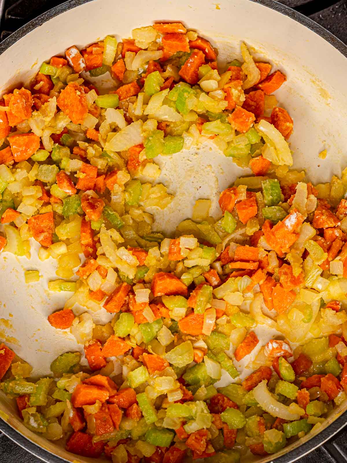 Vegetables softened and lightly golden after cooking in the pan.