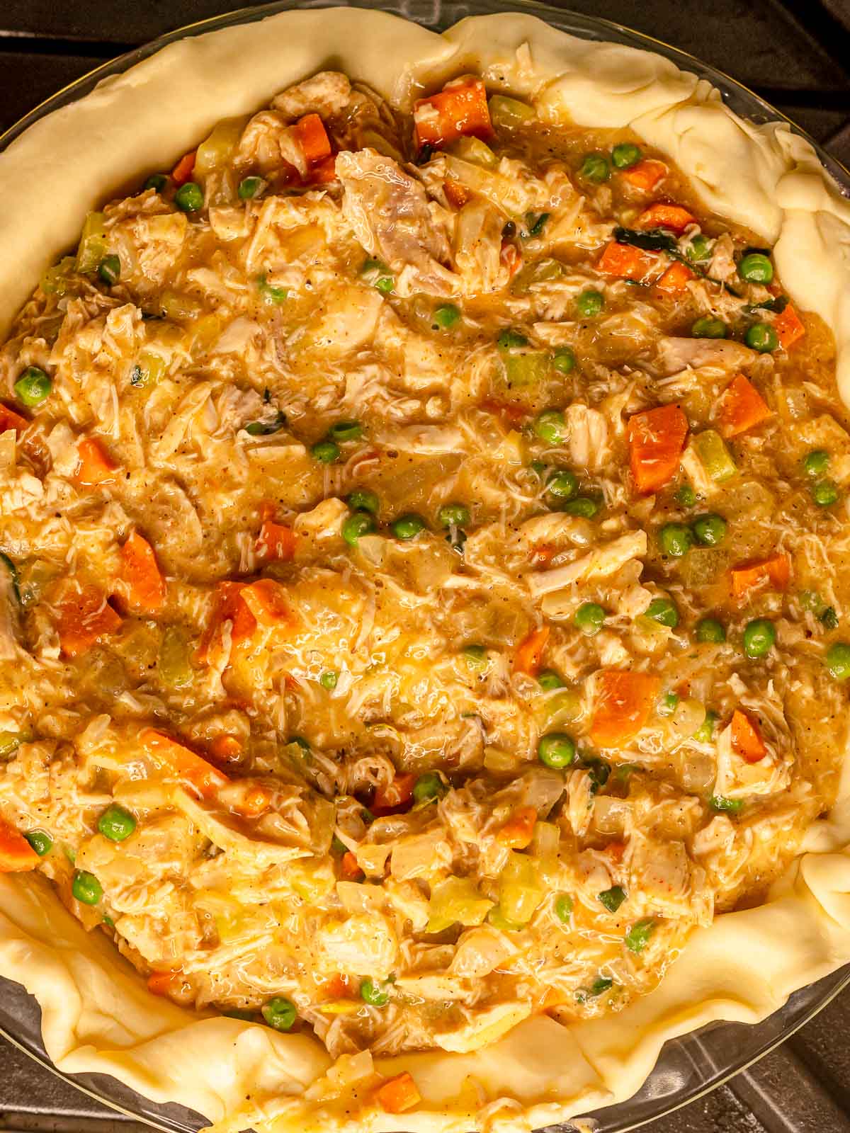 Chicken pot pie filling spread inside a pie crust.