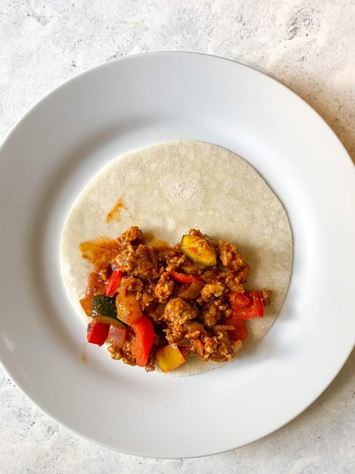 Enchilada mix on tortilla.