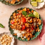 Stir fry with peanuts in a green bowl.