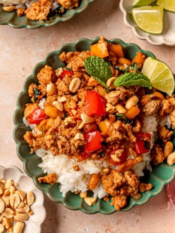 Stir fry with peanuts in a green bowl.