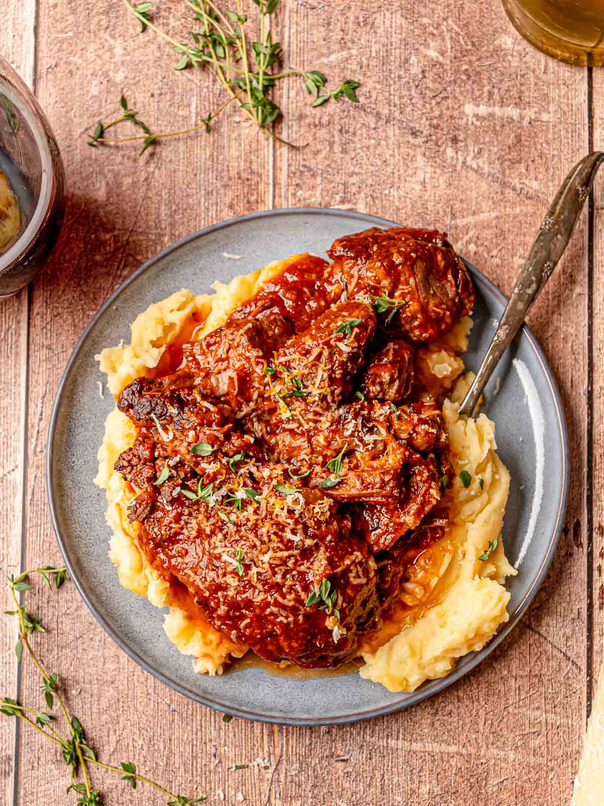 Chunks of Italian pot roast on mashed potatoes with tomato gravy, Parmesan, and thyme.