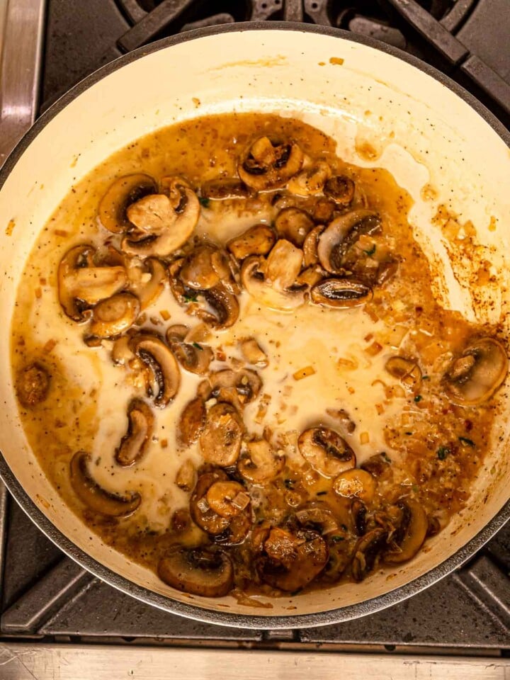 Creamy mushroom sauce beginning to come together in the pan.