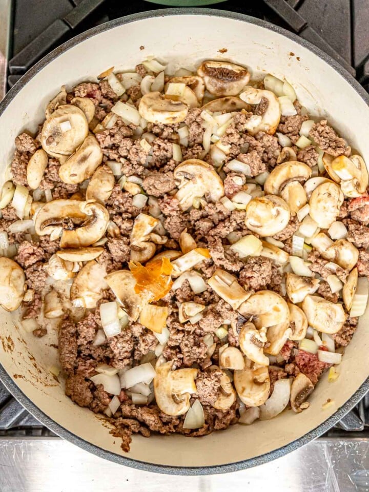 Ground beef, shallot and mushroom in a pan.
