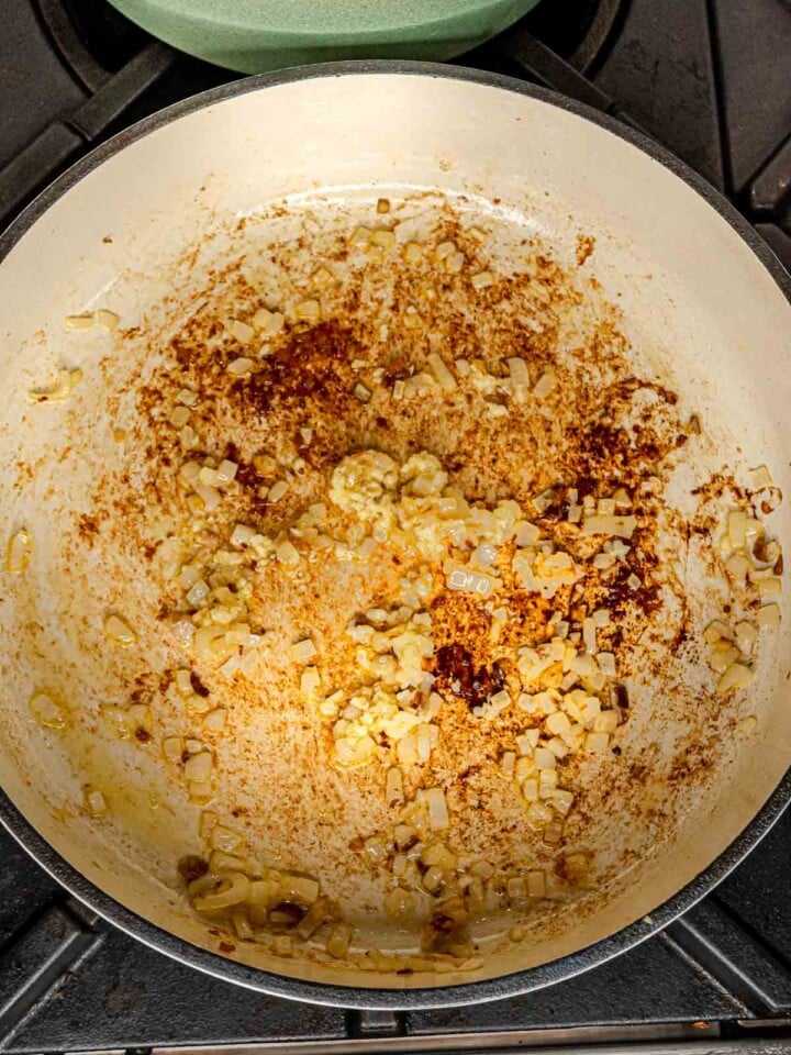 Shallots and garlic sautéed in the same pan with browned bits from the sausage.