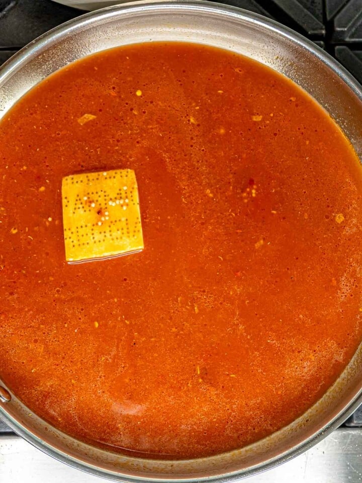 Parmesan rind in a tomato broth.