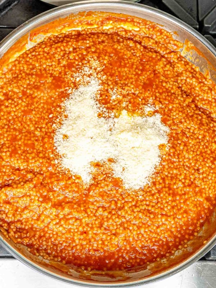 Grated Parmesan cheese stirred into the cooked pastina with tomato sauce.
