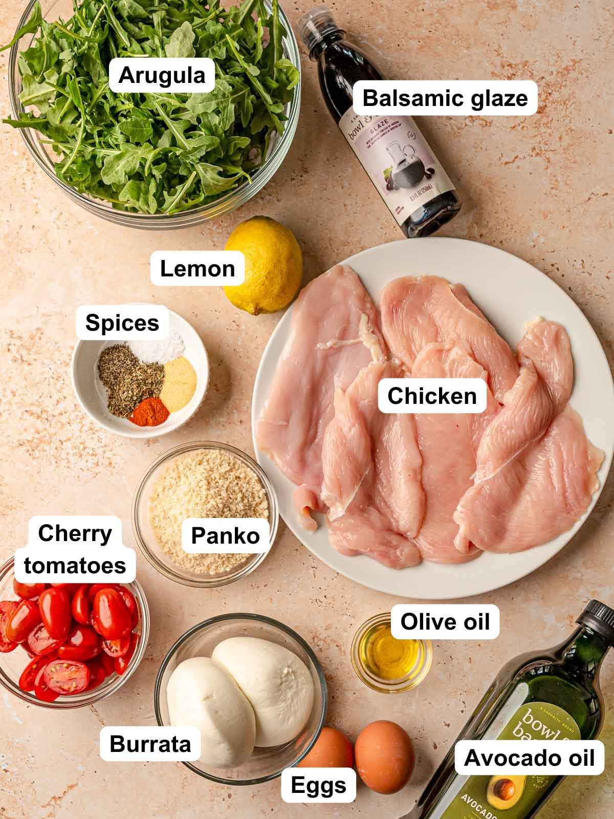 Ingredients for chicken milanese: raw chicken cutlets, arugula, panko, eggs, burrata, cherry tomatoes, lemon, spices, balsamic glaze, olive oil, avocado oil.