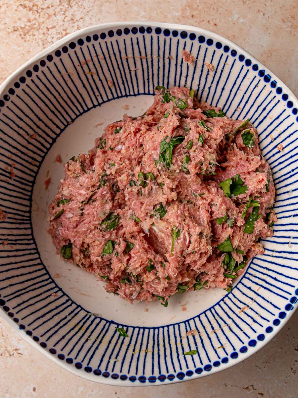 Mixed turkey meatball mixture with visible spinach pieces throughout.