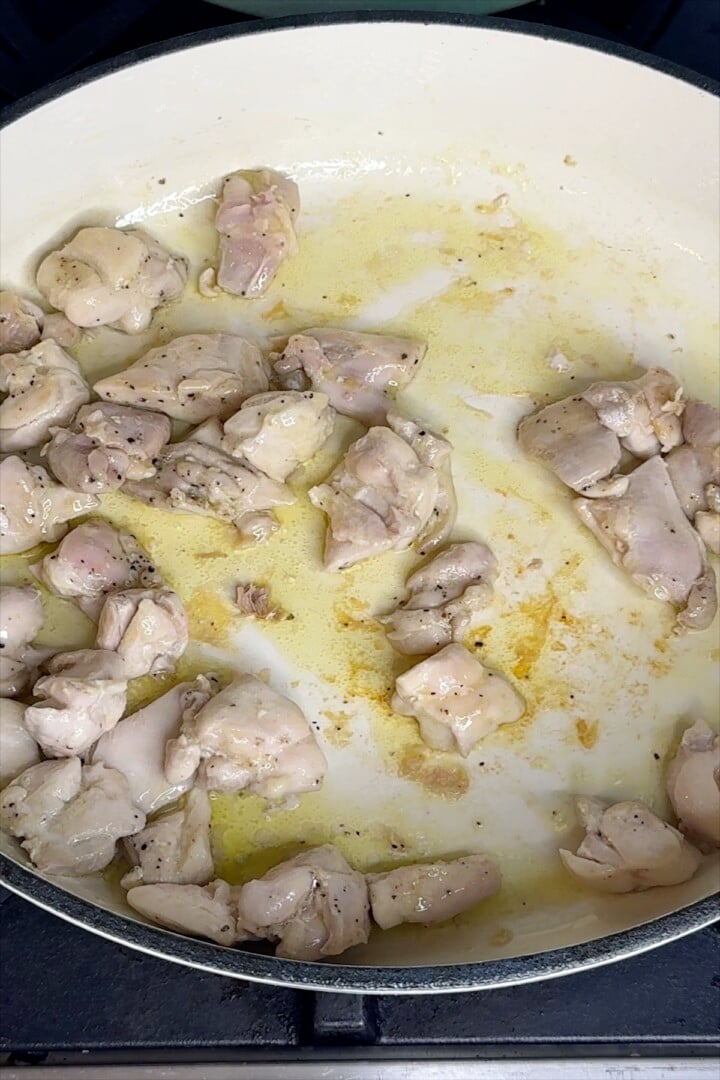 Chicken browning in a skillet.