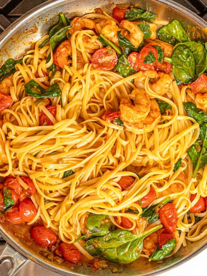 Linguine tossed with shrimp, spinach, and cherry tomatoes in a spicy tomato sauce.