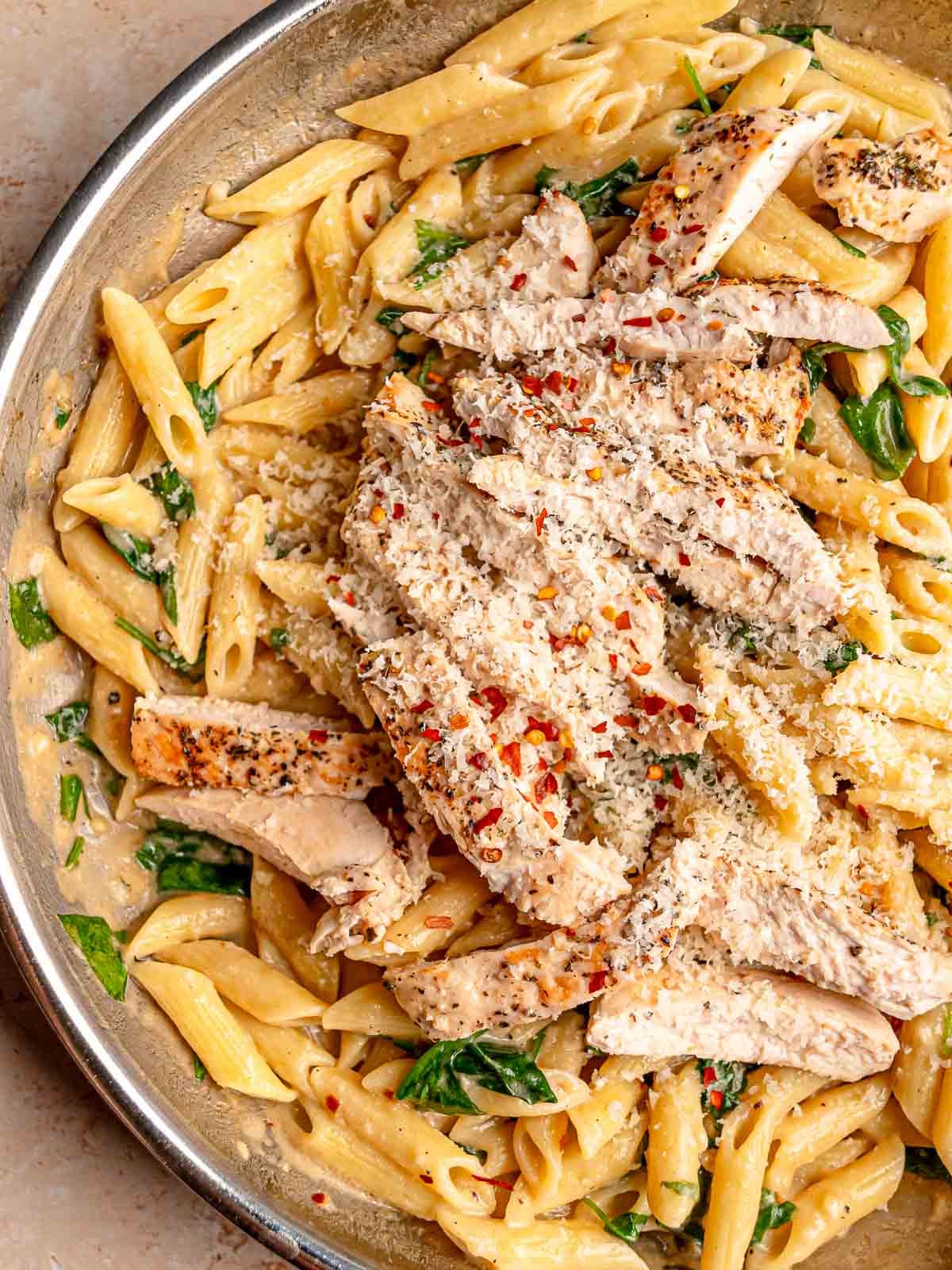 Sliced seasoned chicken over creamy garlic Parmesan penne with spinach, red pepper flakes and freshly grated cheese.
