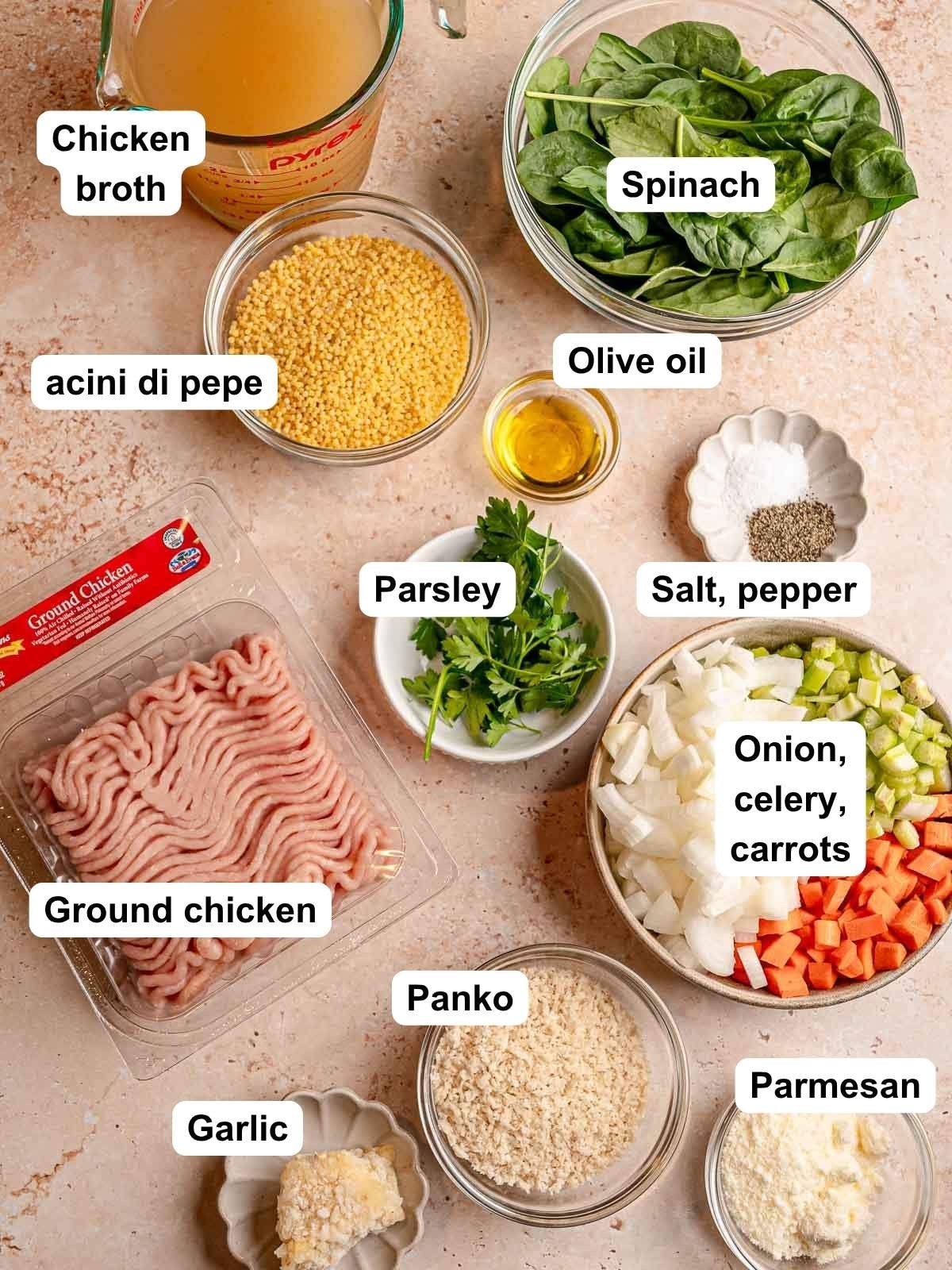 Ingredients for Italian wedding soup with chicken meatballs include ground chicken, acini di pepe, spinach, chicken broth, carrots, celery, onion, Parmesan, panko, garlic, parsley, olive oil, salt, and pepper.
