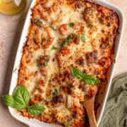 Cheesy no-boil pasta bake with penne, sausage and broccoli in tomato sauce, topped with fresh basil.